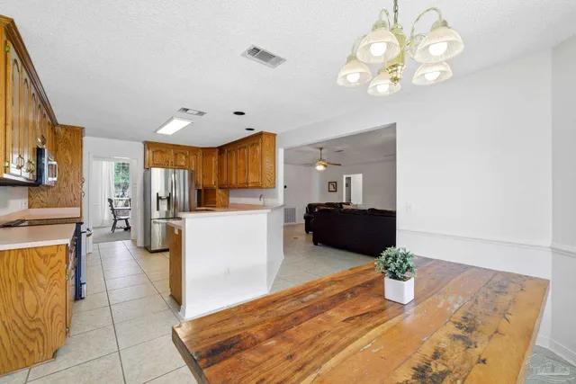 a kitchen with stainless steel appliances granite countertop a sink dishwasher stove and refrigerator