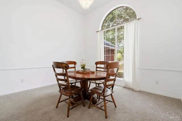 a view of a dining room with furniture window and outside view