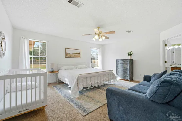 a spacious bedroom with a bed and a couch