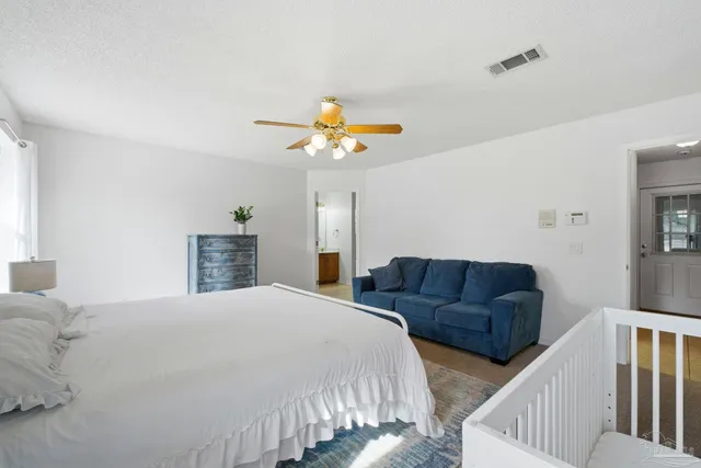 a bedroom with bed and a couch