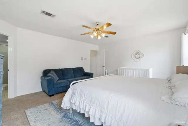 a bedroom with a bed couch and a window