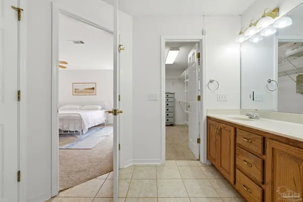 a spacious bathroom with a double vanity sink a mirror and a shower