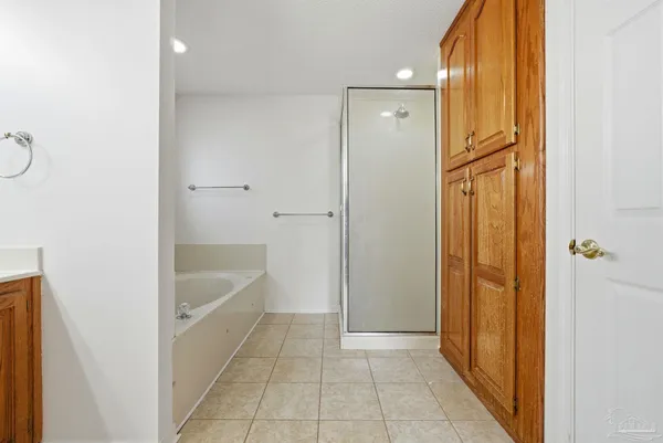 a bathroom with a tub shower and sink