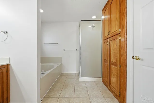 a bathroom with a tub shower and sink