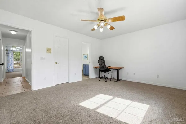 a view of a livingroom with a piano and wooden floor