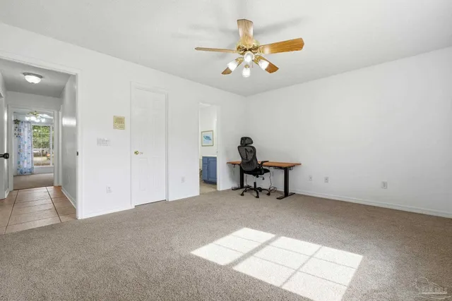 a view of a livingroom with a piano and wooden floor