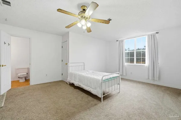 a room with a bed and window