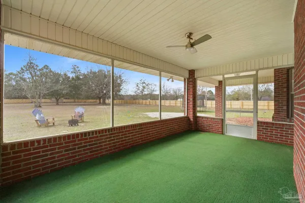 a view of a floor to ceiling window and a yard