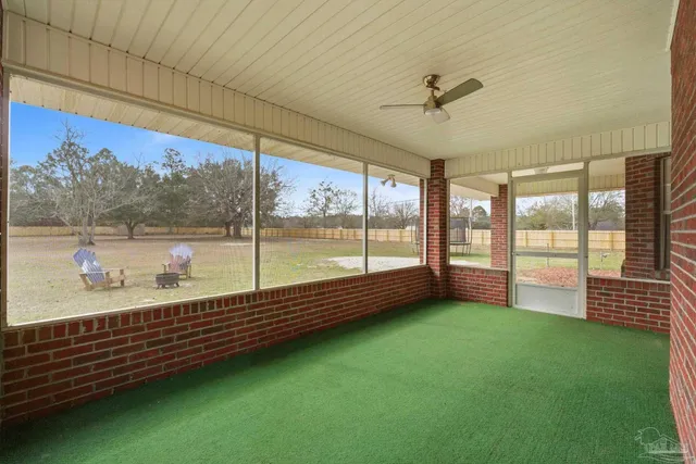 a view of a floor to ceiling window and a yard
