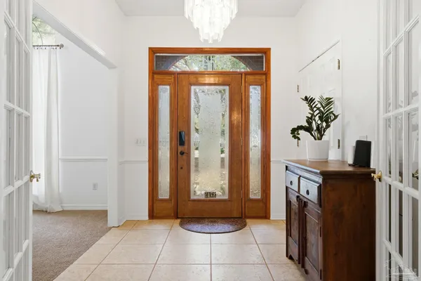 a view of a hallway with entryway and front door