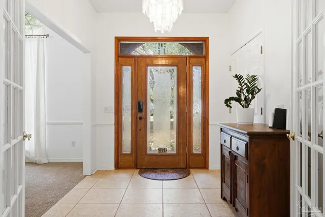 a view of a hallway with entryway and front door