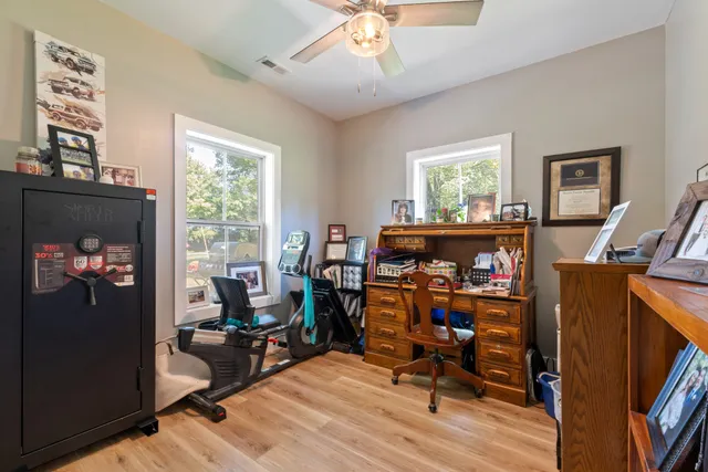 a view of a workspace with furniture and a window
