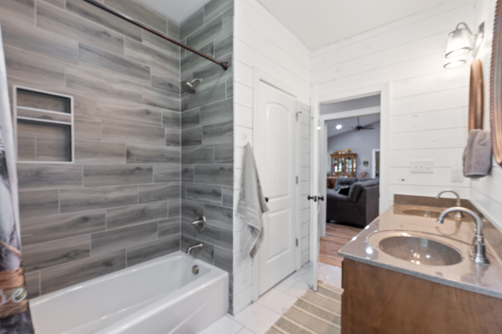 232 Clyde Vickers Road Estill Springs, TN 37330 - Photo 20 of 25 a bathroom with a granite countertop sink a bathtub and shower