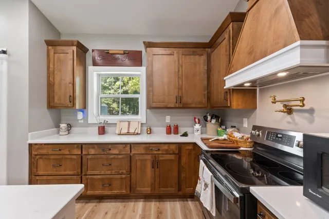a kitchen with a sink a stove and cabinets