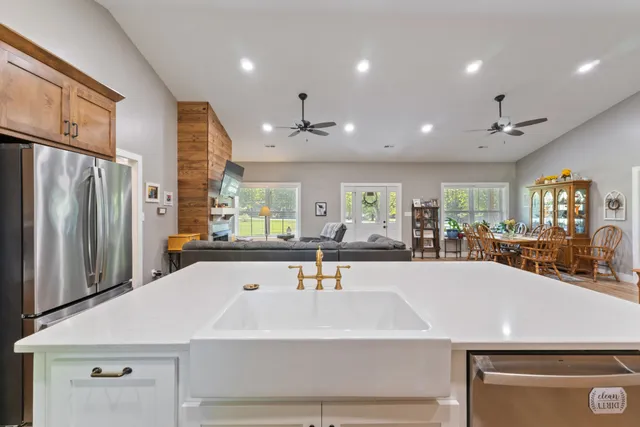 a large kitchen with stainless steel appliances a large counter top