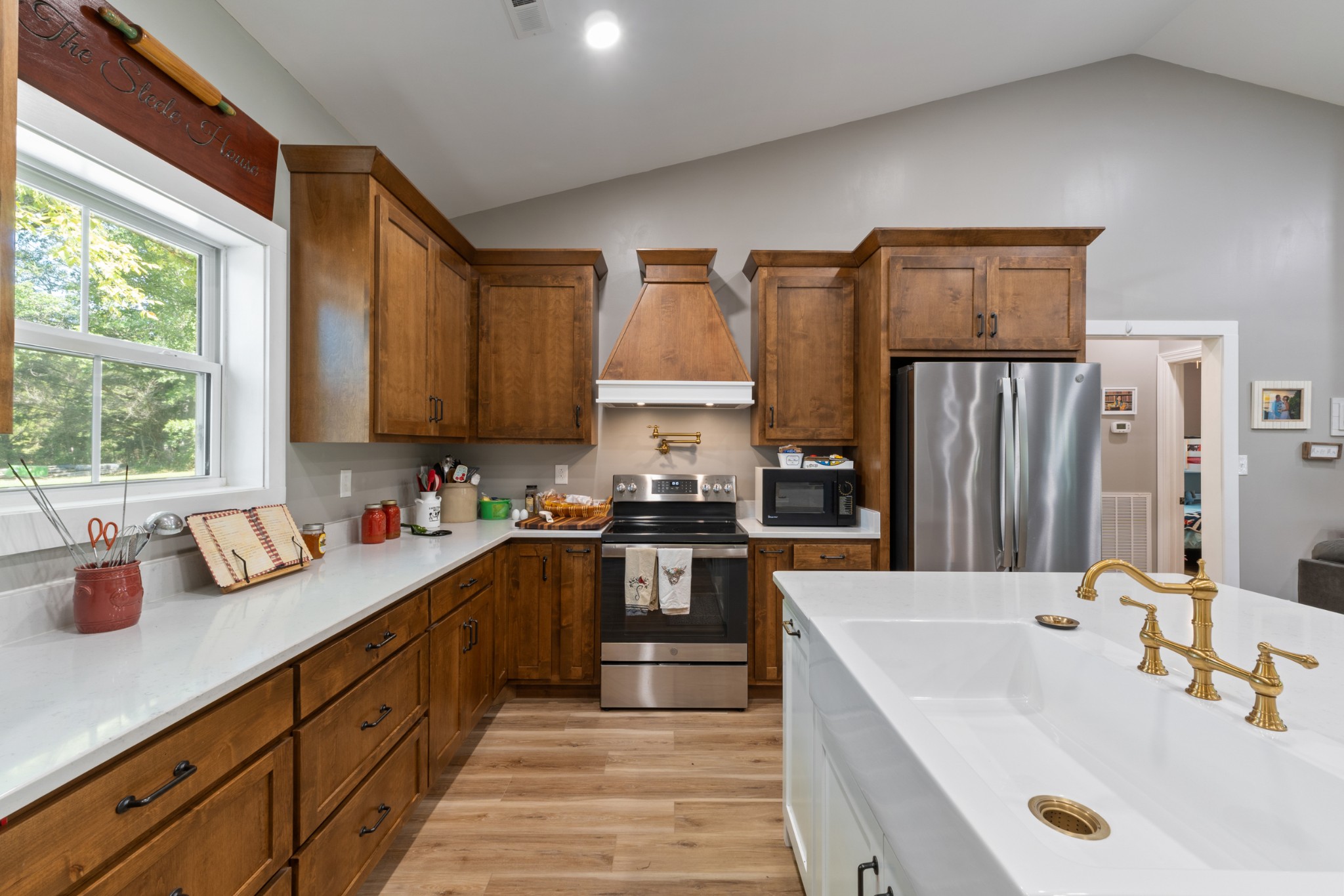 232 Clyde Vickers Road Estill Springs, TN 37330 - Photo 10 of 25 a kitchen with kitchen island granite countertop a sink stove and refrigerator