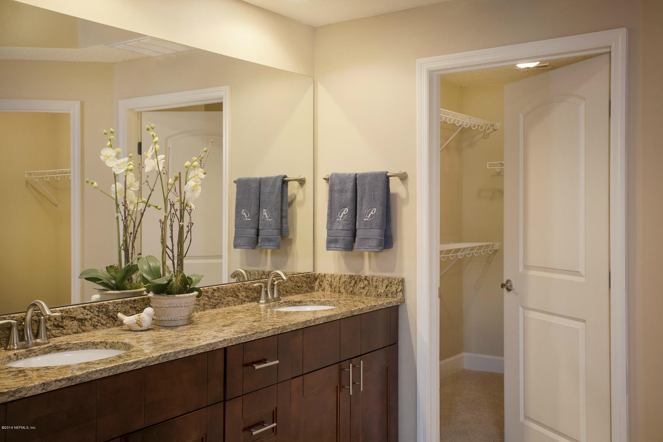 3958 Baymeadows Road, Unit 2202 Jacksonville, FL 32217 - Photo 9 of 9 a bathroom with a double vanity sink and a mirror