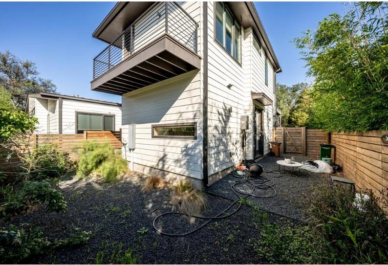 203 East 46th Street Austin, TX 78751 - Photo 13 of 13 Rear view of house with a balcony, a fenced backyard, and a gate