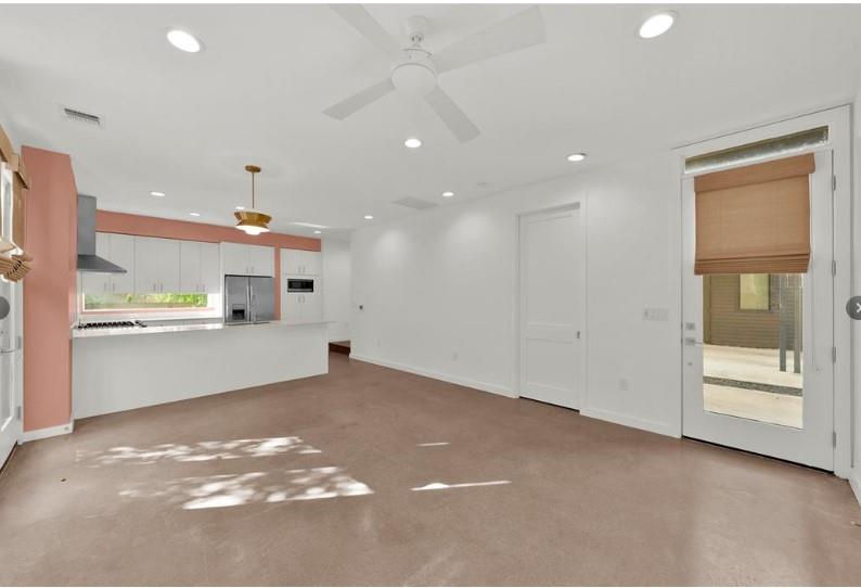 203 East 46th Street Austin, TX 78751 - Photo 5 of 13 Unfurnished living room with a ceiling fan, recessed lighting, and finished concrete flooring