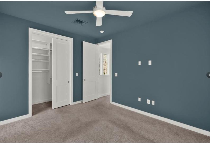 203 East 46th Street Austin, TX 78751 - Photo 8 of 13 Unfurnished bedroom with carpet, a closet, and a ceiling fan