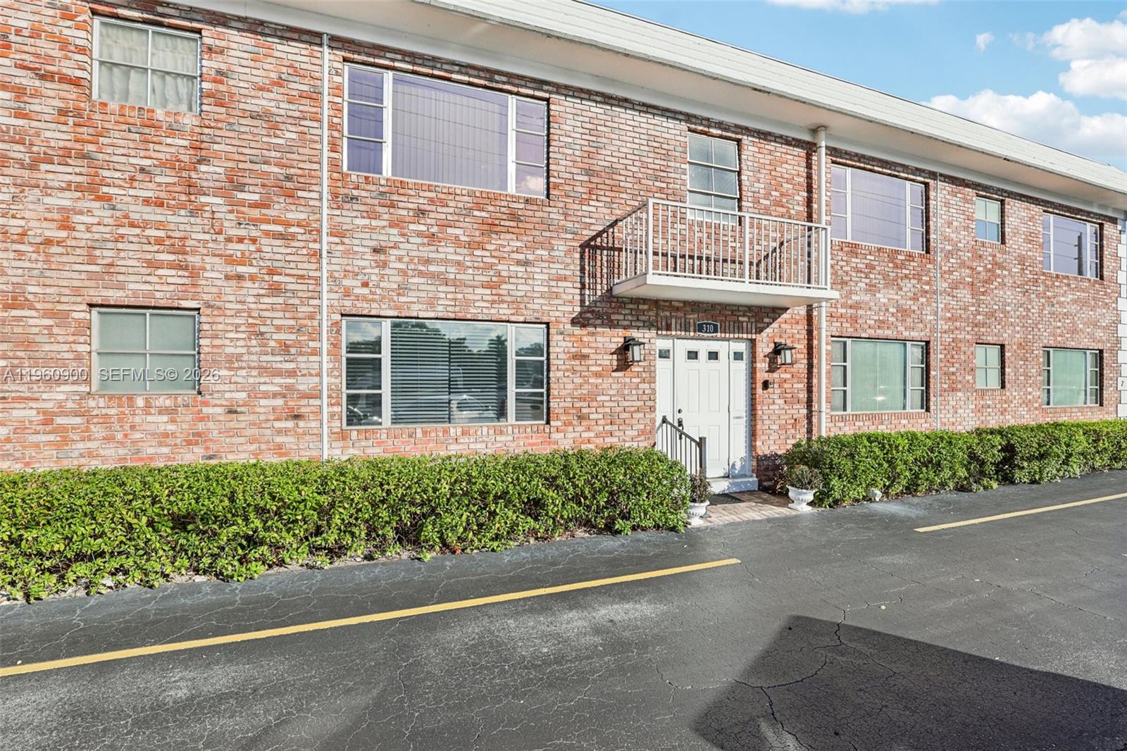 front view of a brick house with a street