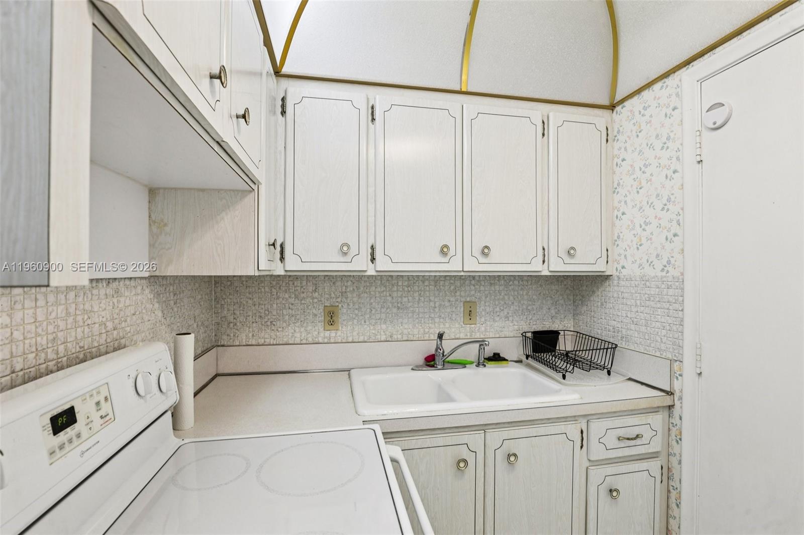 310 South Cypress Road, Unit 730 Pompano Beach, FL 33060 - Photo 12 of 26 a view of a kitchen with cabinets and washer