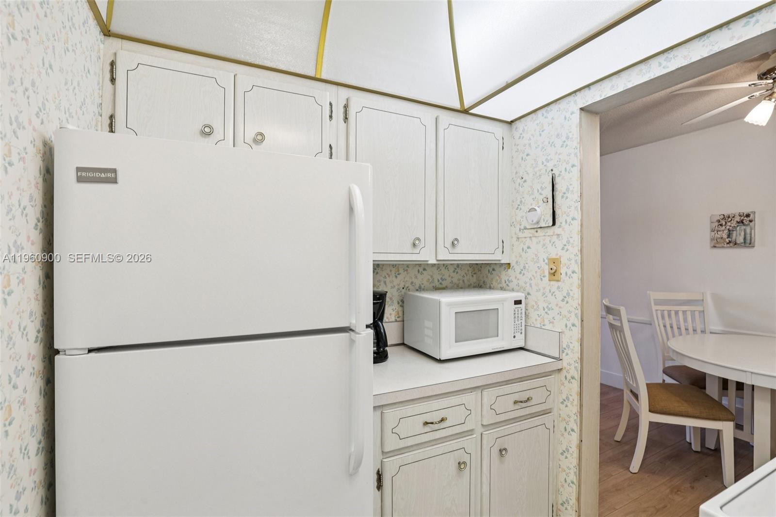 310 South Cypress Road, Unit 730 Pompano Beach, FL 33060 - Photo 13 of 26 a kitchen with white cabinets and white appliances