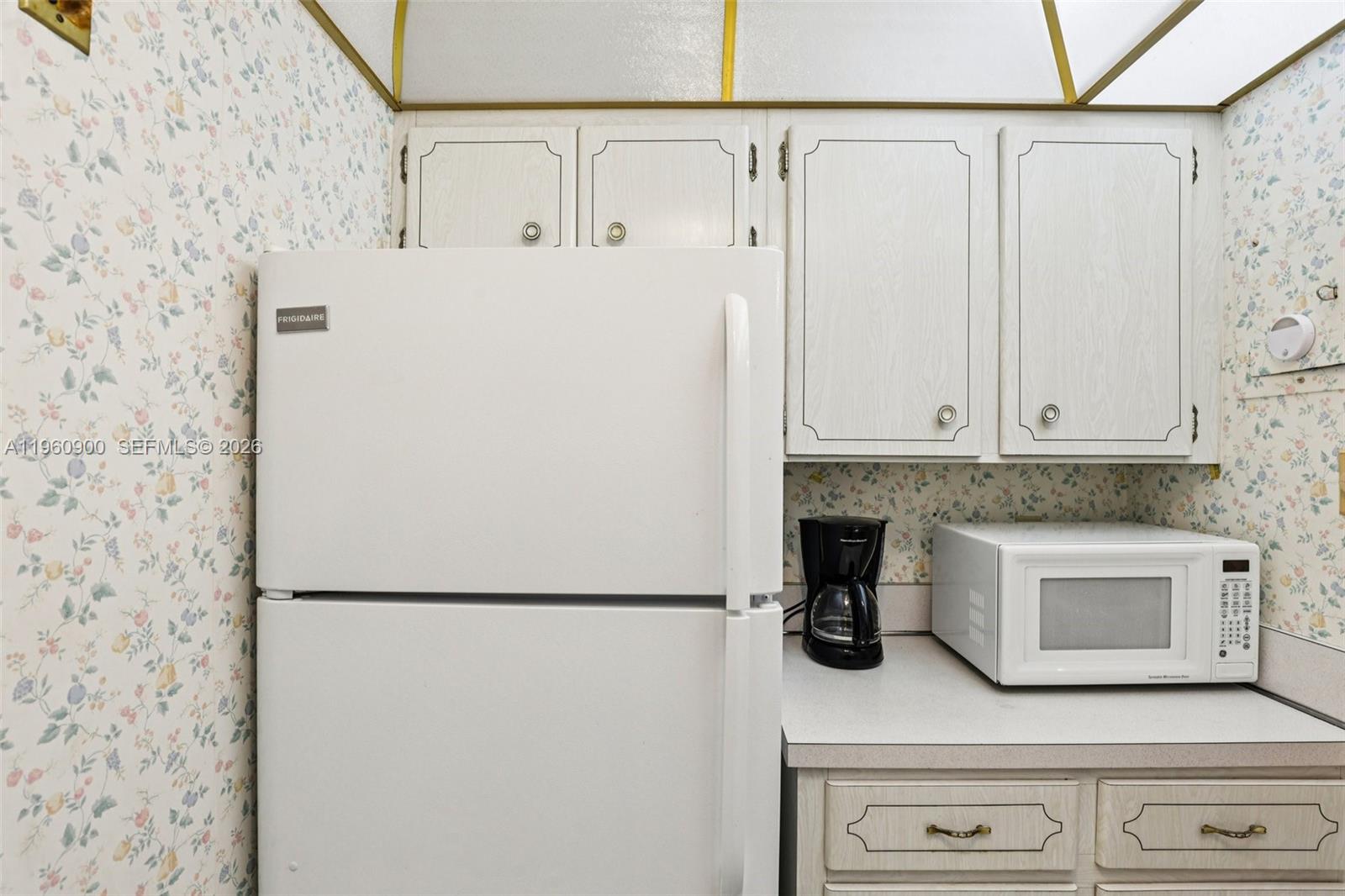 310 South Cypress Road, Unit 730 Pompano Beach, FL 33060 - Photo 14 of 26 a white refrigerator freezer sitting inside of a kitchen