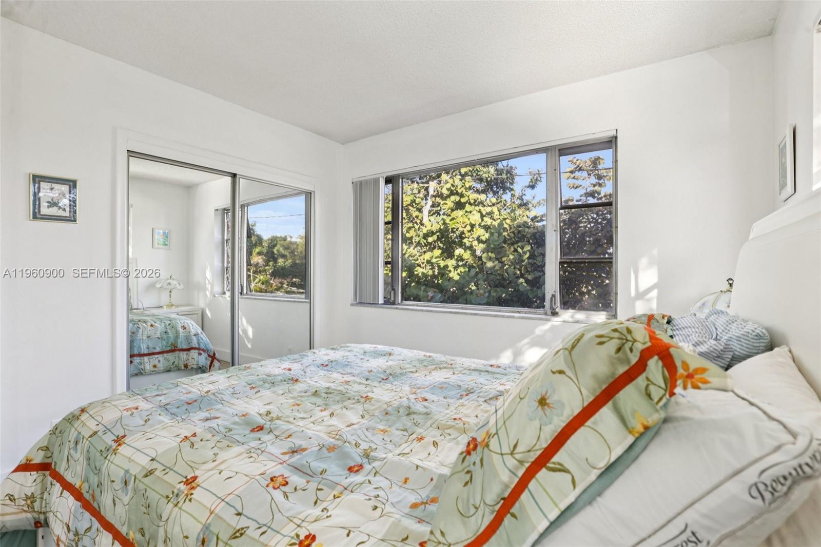 310 South Cypress Road, Unit 730 Pompano Beach, FL 33060 - Photo 16 of 26 a bed sitting in a bedroom next to a window