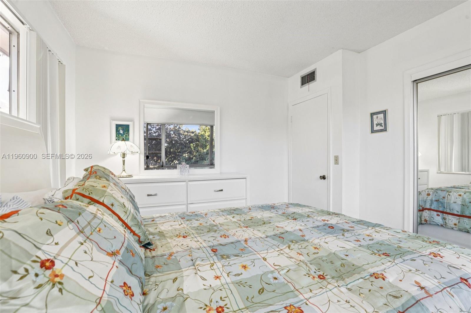 310 South Cypress Road, Unit 730 Pompano Beach, FL 33060 - Photo 17 of 26 a bedroom with a bed and a window