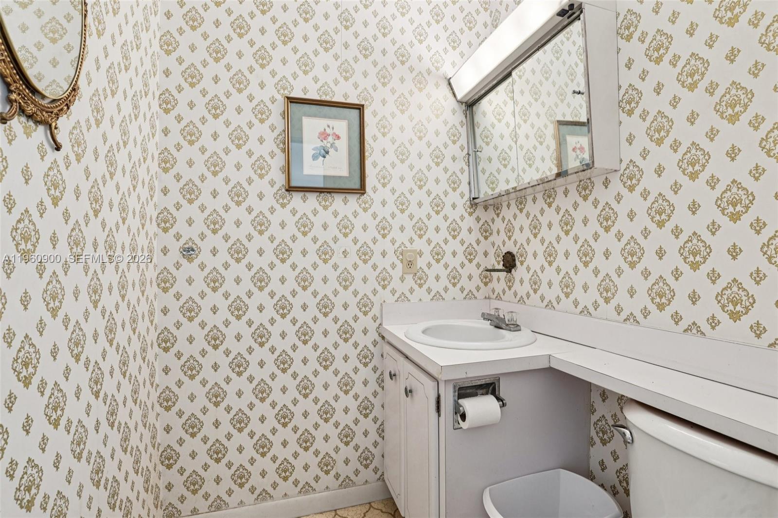 310 South Cypress Road, Unit 730 Pompano Beach, FL 33060 - Photo 25 of 26 a bathroom with a sink and a mirror