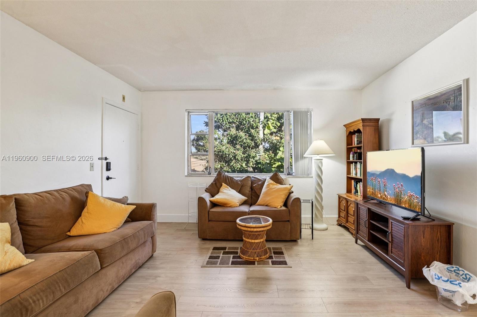 310 South Cypress Road, Unit 730 Pompano Beach, FL 33060 - Photo 8 of 26 a living room with furniture rug and a window