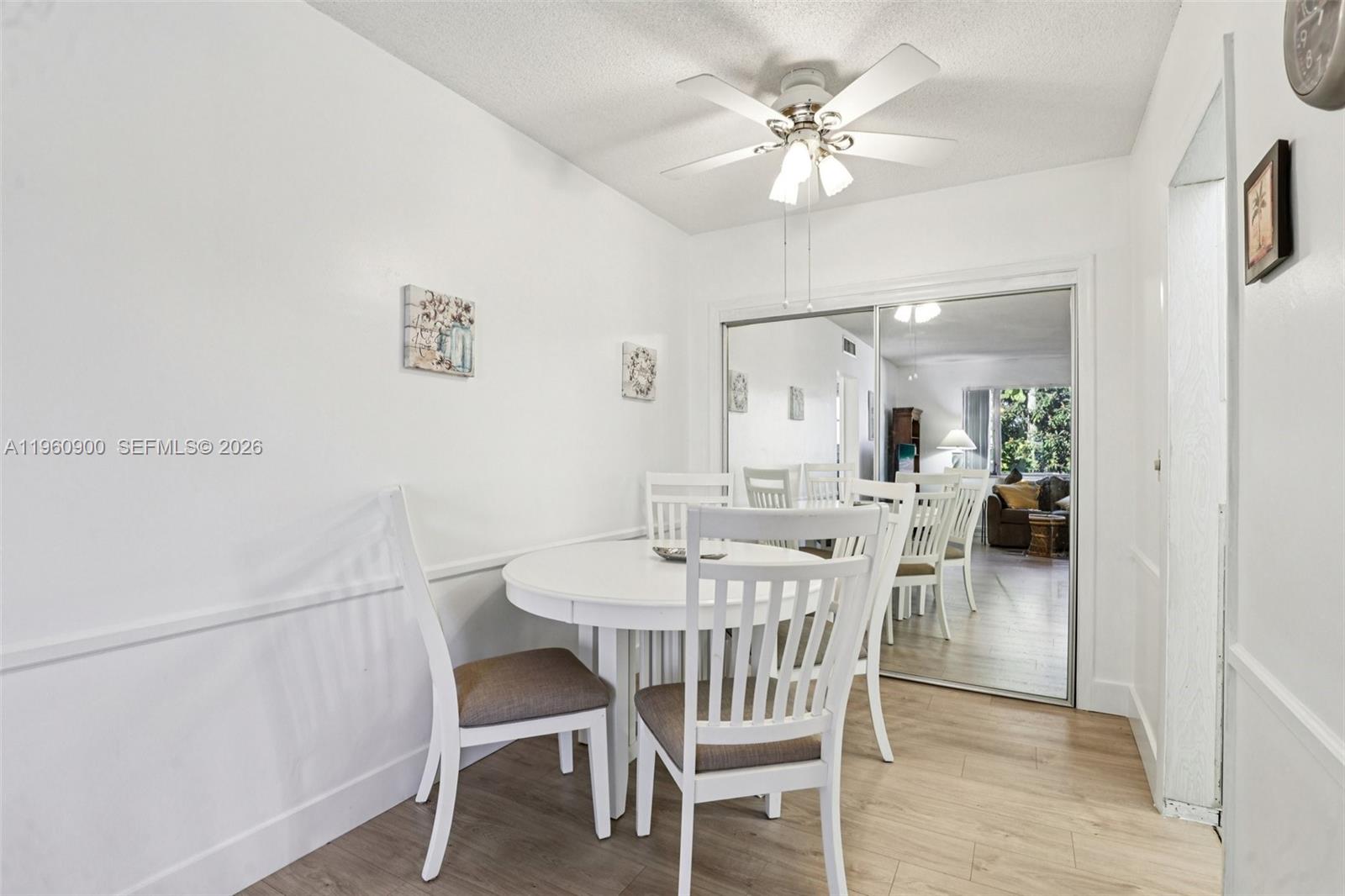 310 South Cypress Road, Unit 730 Pompano Beach, FL 33060 - Photo 9 of 26 a view of a dining room with furniture and a chandelier fan