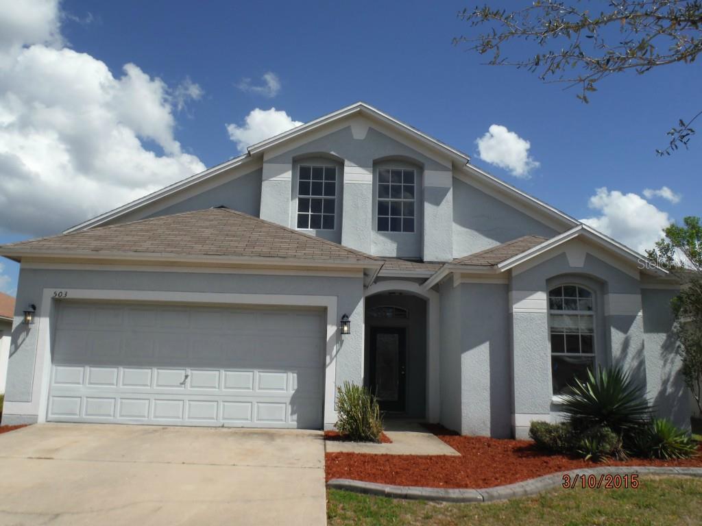 503 Caribe Ridge Way Ruskin, FL 33570 - Photo 1 of 1 a front view of a house with a yard and garage