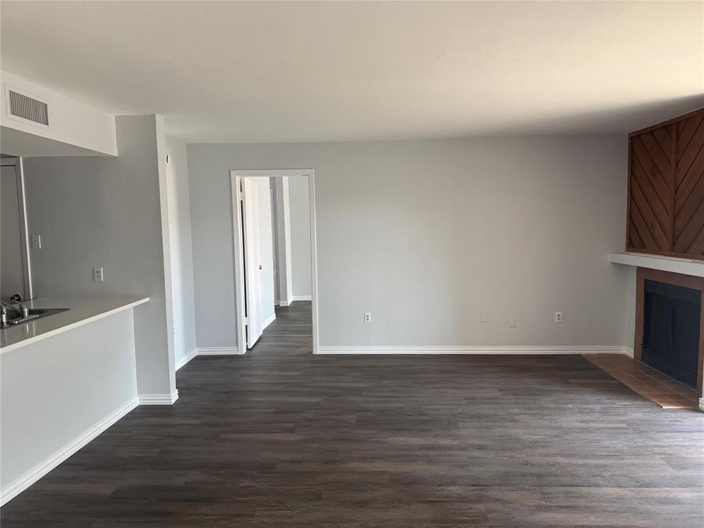 12482 Abrams Road Dallas, TX 75243 - Photo 1 of 4 a view of an empty room with wooden floor and a window