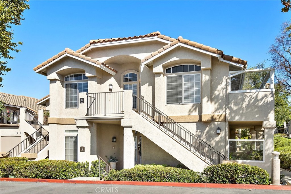 8 Carmesi Rancho Santa Margarita, CA 92688 - Photo 1 of 1 8 Carmesi is South East facing ,upper right end unit ,porch in the front large balcony on the side. Direct garage access , YES DIRECT GARAGE ACCESS !!!!!!