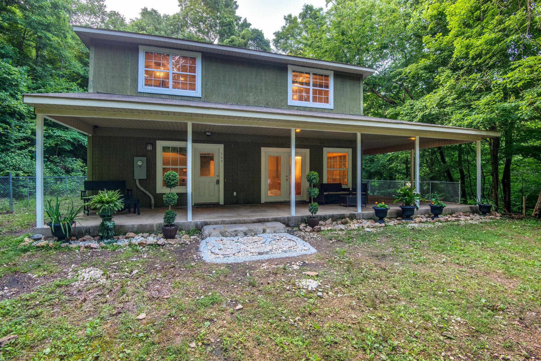 549 Porter Hollow Road Linden, TN 37096 - Photo 2 of 30 Unique wooded, hillside home with lush landscaping has abundant privacy!