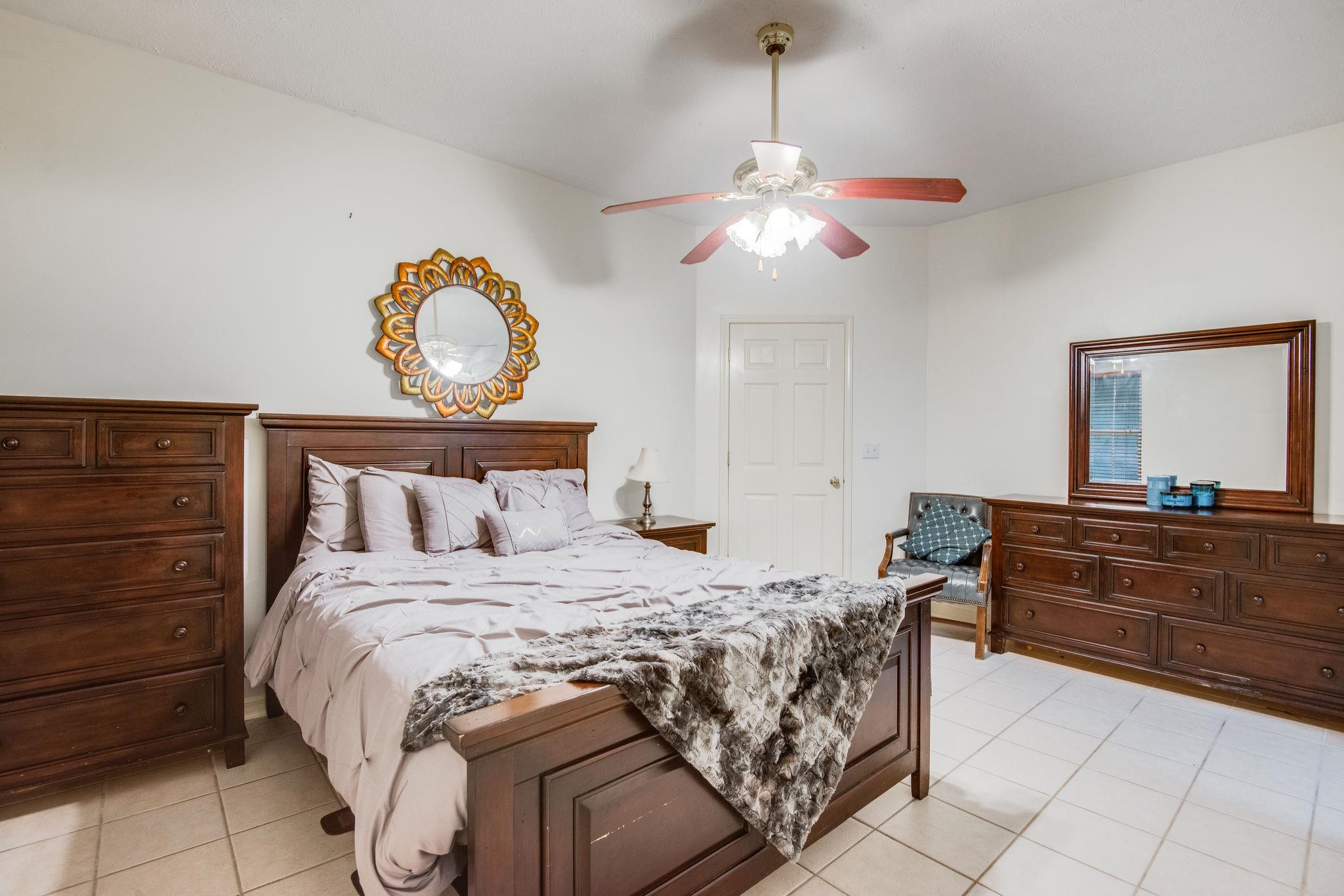 549 Porter Hollow Road Linden, TN 37096 - Photo 11 of 30 Large master suite on the main floor has ceiling fan, adjacent bath, and large walk-in closet.