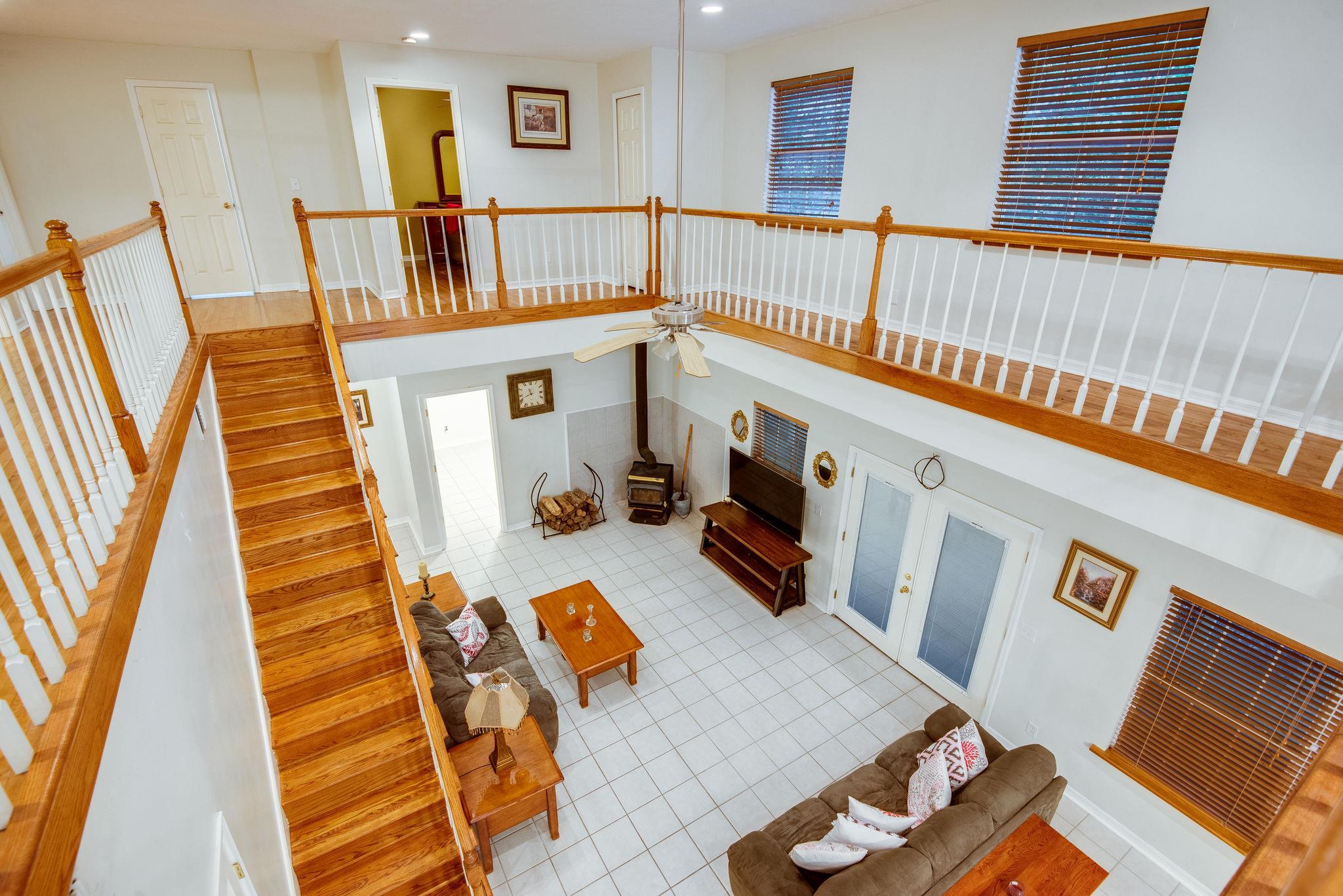 549 Porter Hollow Road Linden, TN 37096 - Photo 3 of 30 The wrap around balcony upstairs provides openness and view of common areas below.
