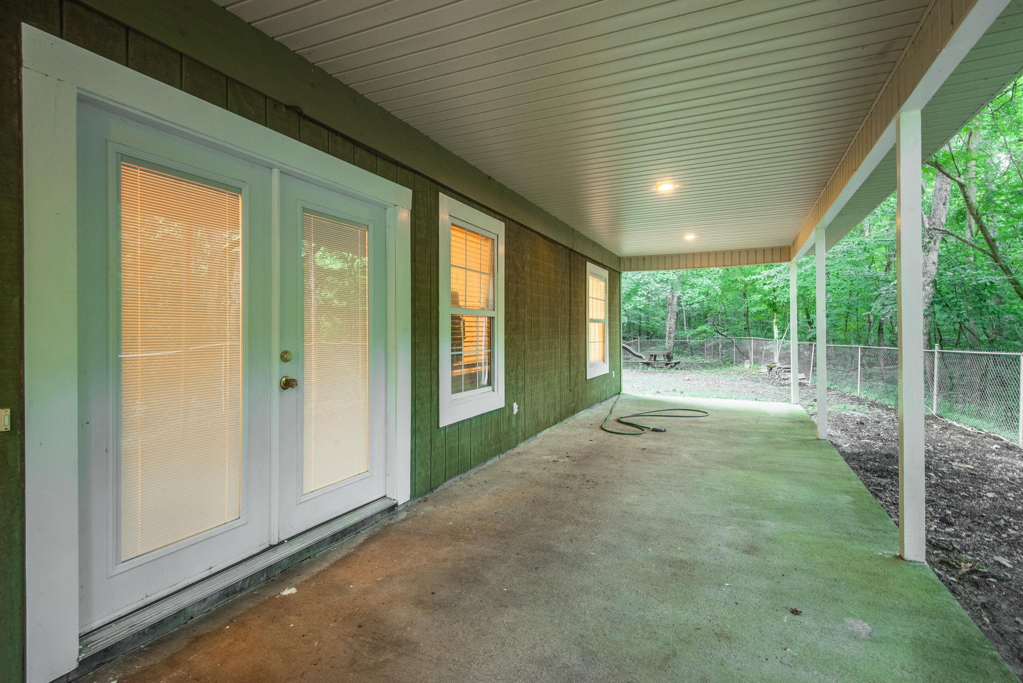 549 Porter Hollow Road Linden, TN 37096 - Photo 5 of 30 Covered Porch on the side offers beautiful wooded views.