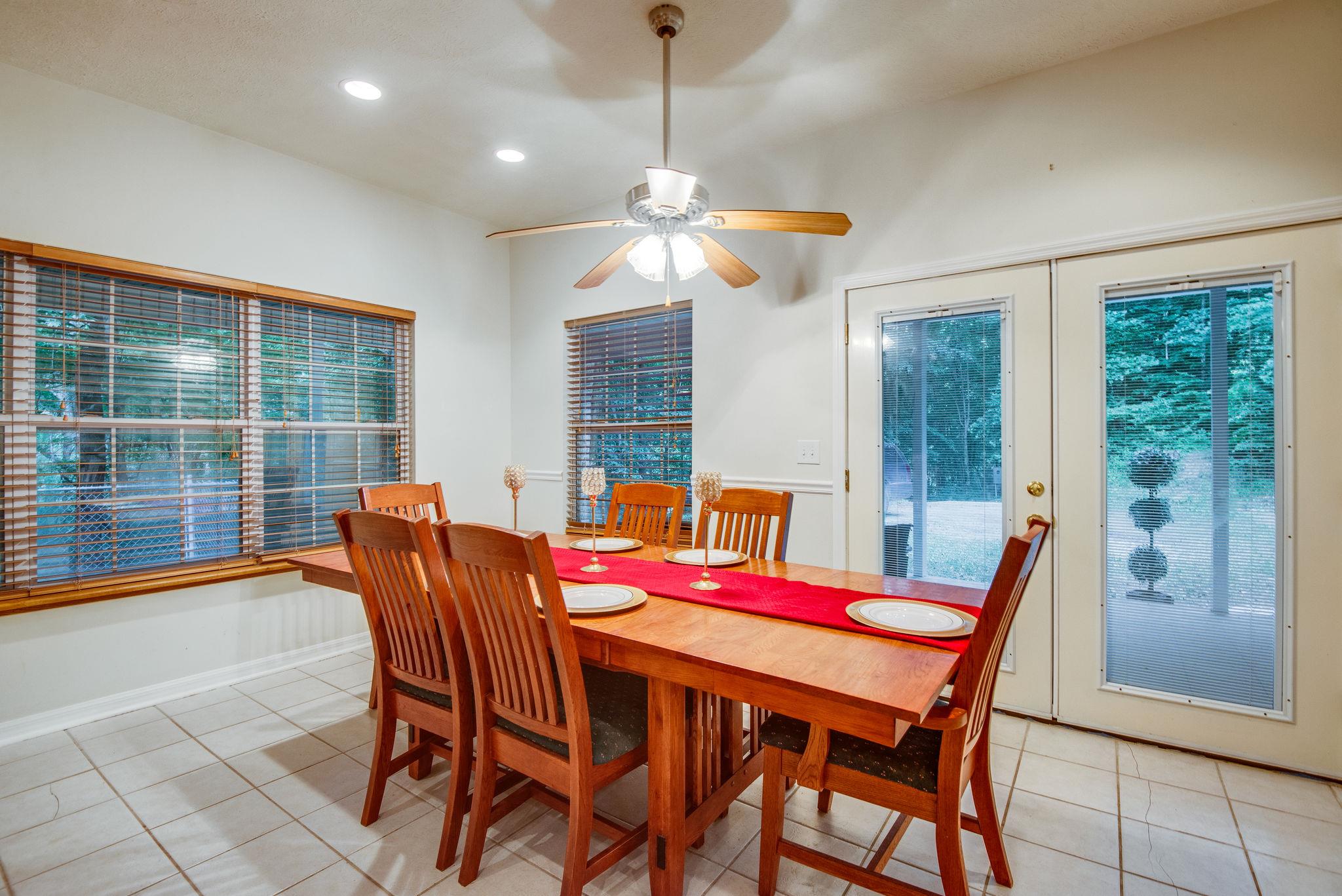 549 Porter Hollow Road Linden, TN 37096 - Photo 6 of 30 Large dining area has extra doors and windows to allow natural light.