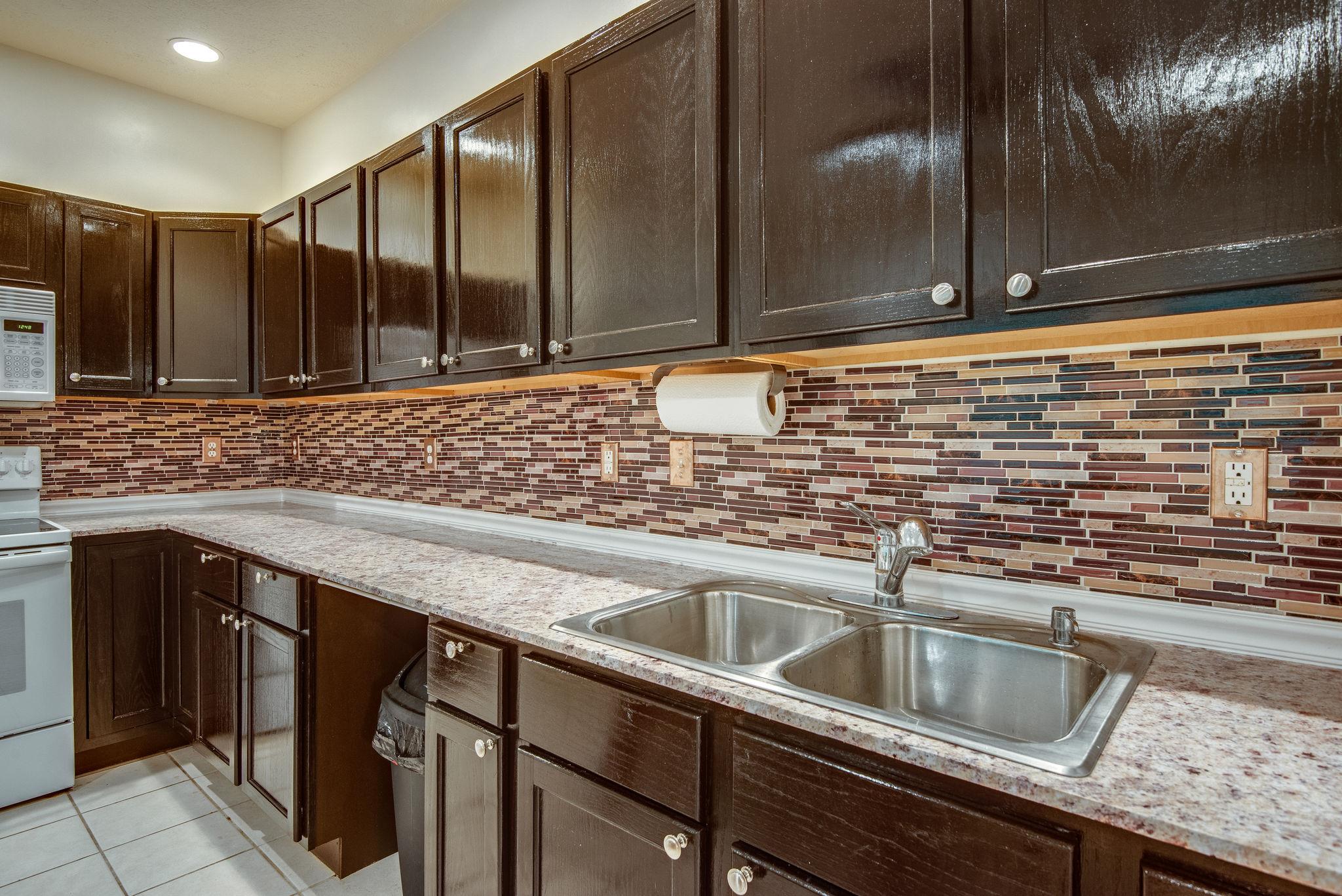 549 Porter Hollow Road Linden, TN 37096 - Photo 8 of 30 Kitchen features new granite counter, new glass tile back splash and refinished cabinets.