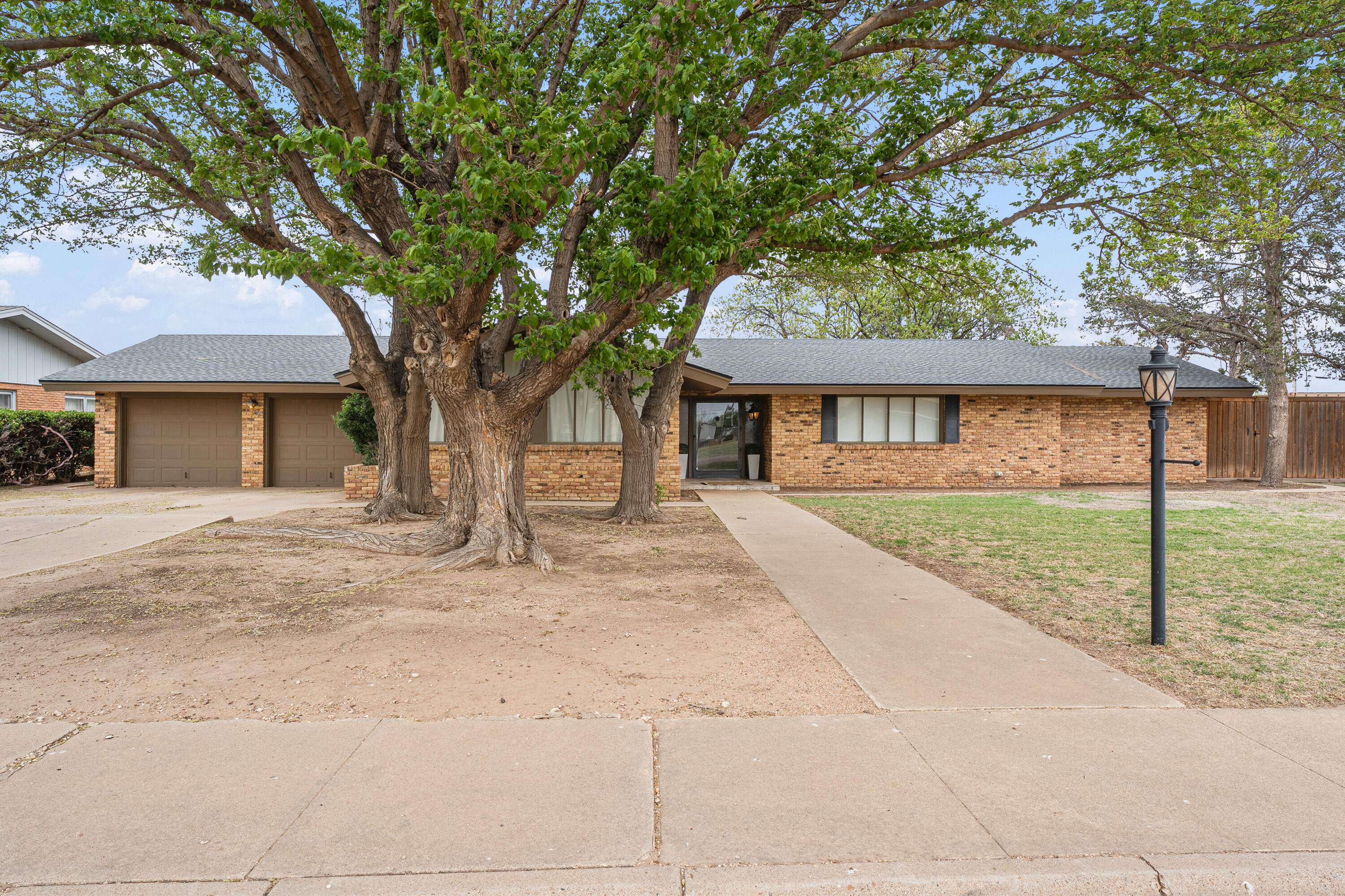 1304 Ave J Ralls, TX 79357 - Photo 1 of 32 a house with trees in front of it