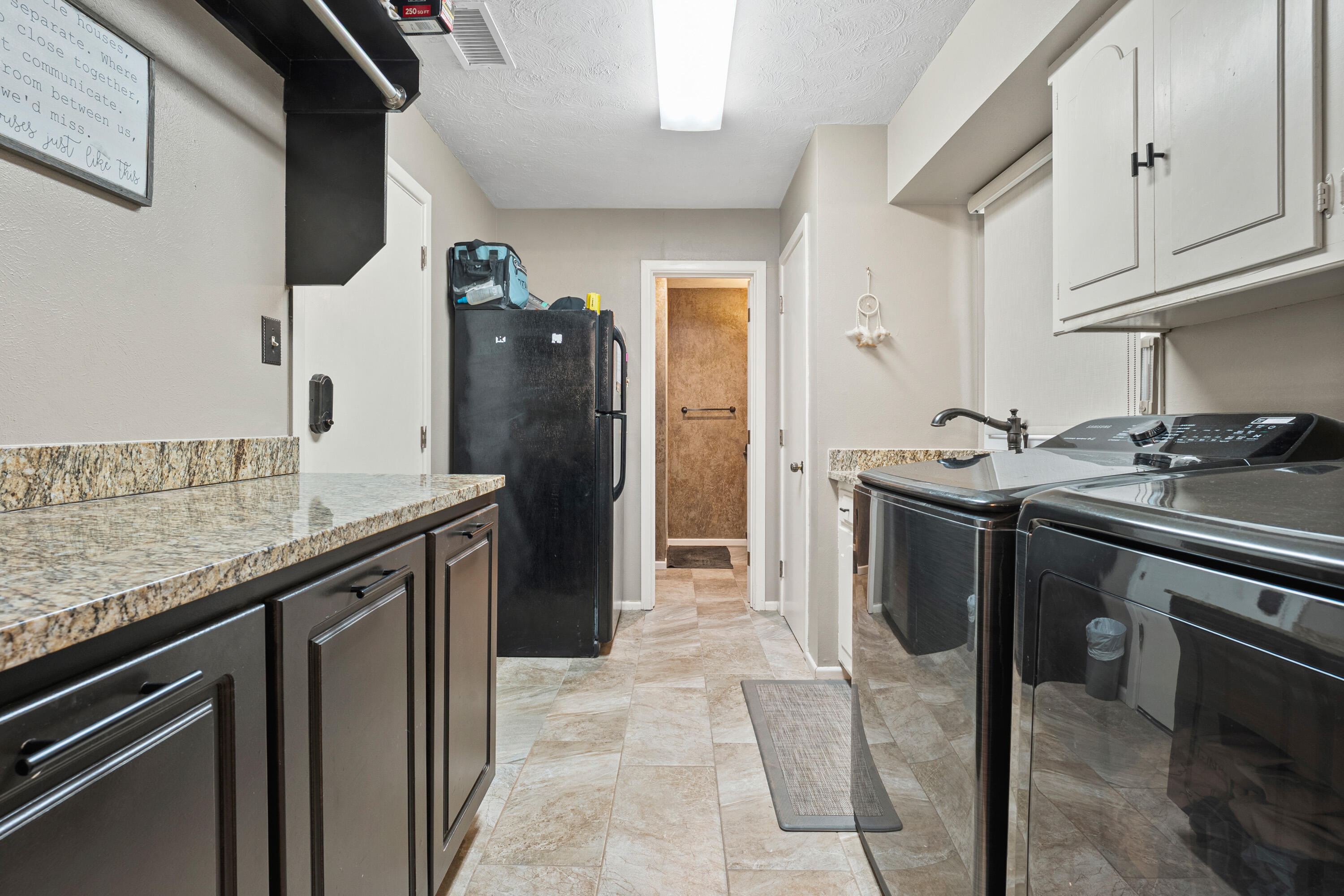 1304 Ave J Ralls, TX 79357 - Photo 15 of 32 a kitchen with stainless steel appliances granite countertop a sink stove and refrigerator