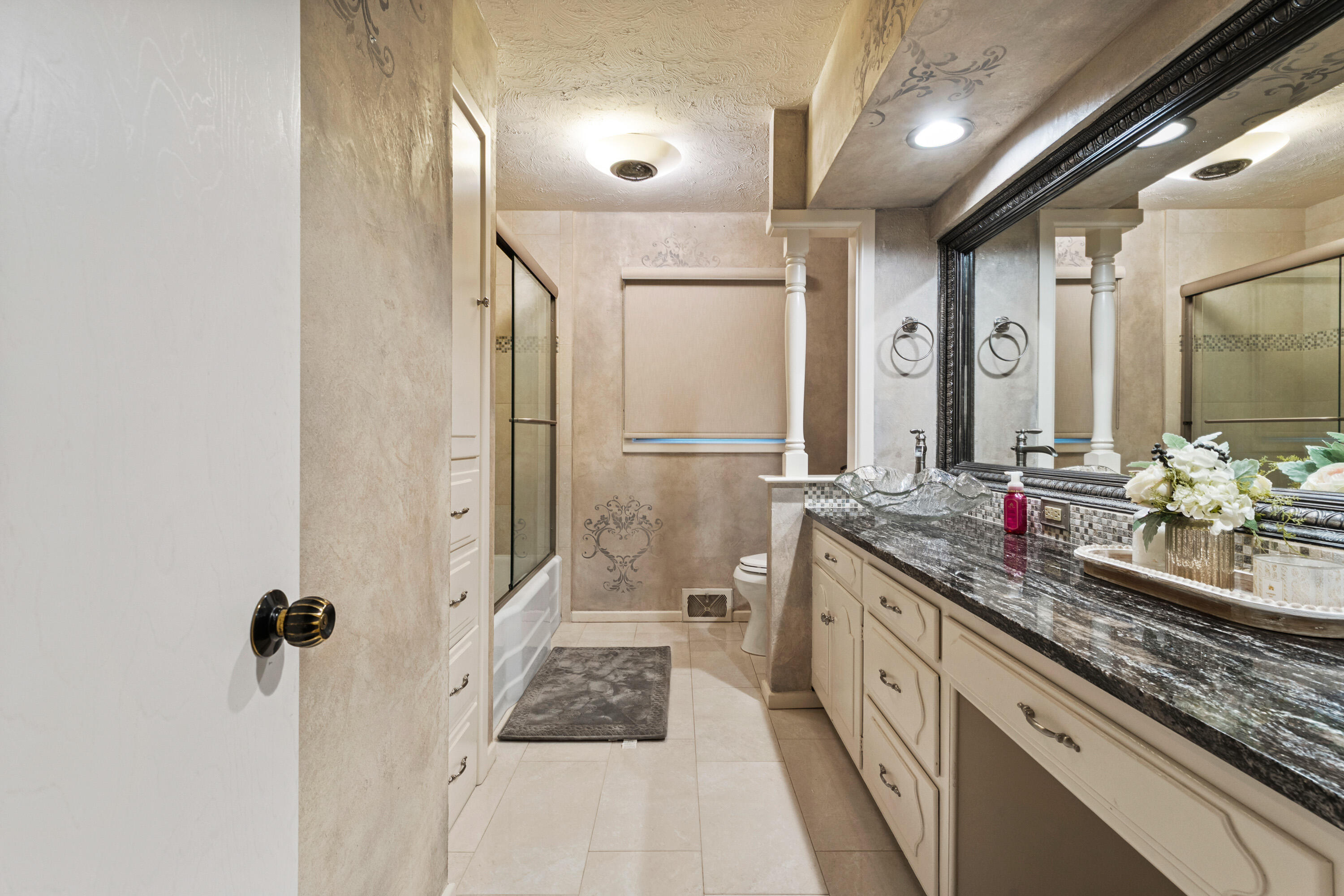 1304 Ave J Ralls, TX 79357 - Photo 17 of 32 a bathroom with a granite countertop sink a mirror and a shower