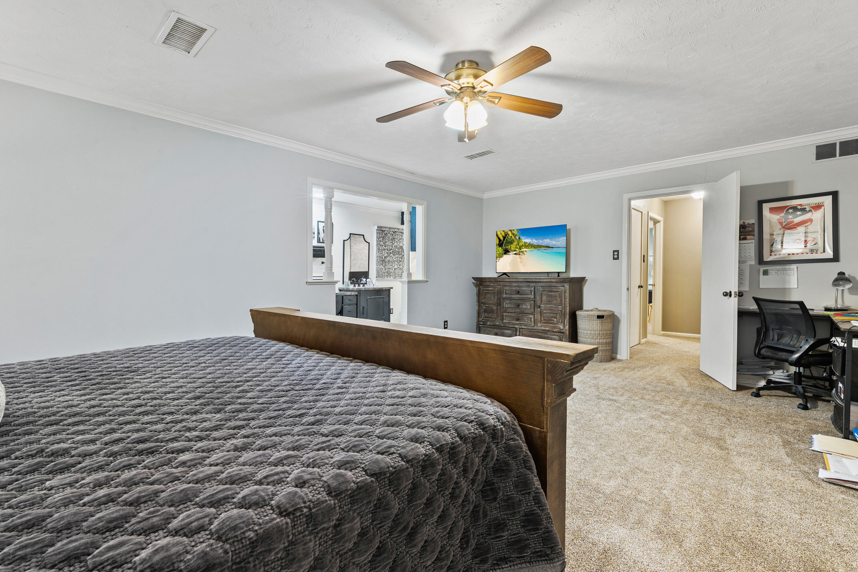 1304 Ave J Ralls, TX 79357 - Photo 23 of 32 a bedroom with a bed and a chandelier