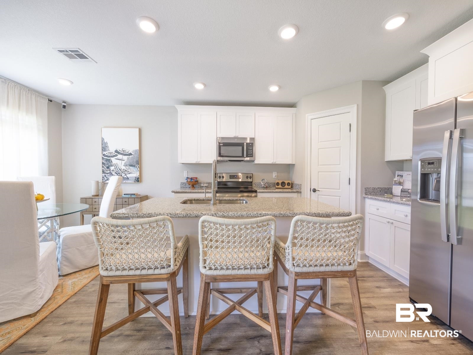 23911 Peppermint Street Elberta, AL 36530 - Photo 5 of 18 Kitchen featuring stainless steel appliances, white cabinetry, a kitchen bar, and recessed lighting