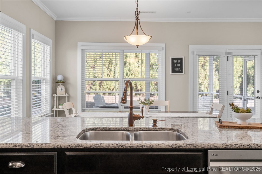 994 Micahs Way North Spring Lake, NC 28390 - Photo 13 of 42 a kitchen with granite countertop a sink and a window