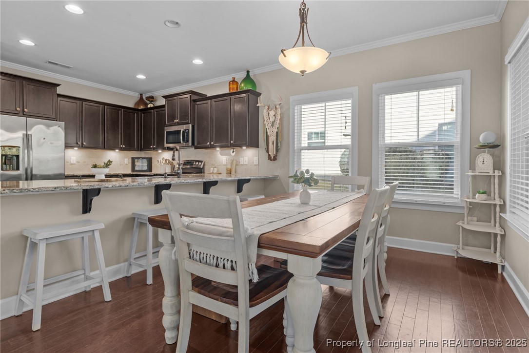 994 Micahs Way North Spring Lake, NC 28390 - Photo 15 of 42 a kitchen with kitchen island a dining table and chairs