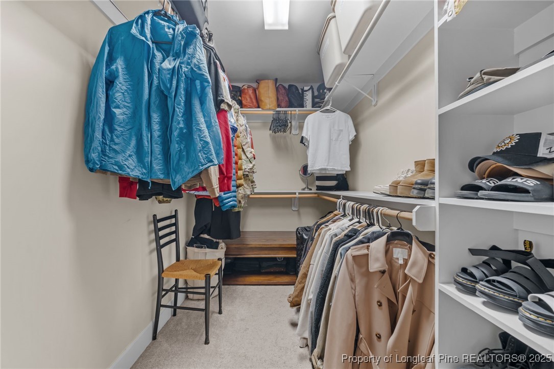 994 Micahs Way North Spring Lake, NC 28390 - Photo 19 of 42 a view of walk in closet with clothes and shoes